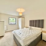 Modern bedroom with double bed and wardrobe
