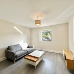 Minimalist living room with sofa and coffee table.