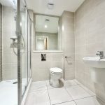 Modern bathroom with shower, toilet, and sink