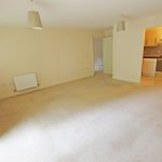 Spacious living room with open kitchen area.