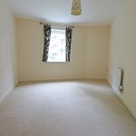 Empty room with window and patterned curtains