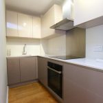 Modern kitchen with sleek grey cabinets.