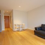 Stylish modern apartment living room with wooden flooring.