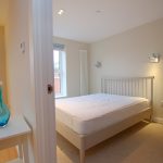 Modern bedroom with double bed and natural light