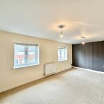 Empty room with two windows and light bulbs.
