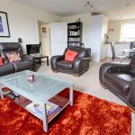 Modern living room with leather furniture and decor.
