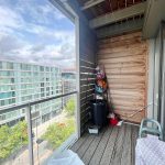 Balcony view overlooking modern apartment buildings.
