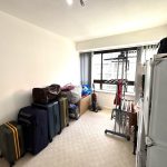 Room with packed suitcases and storage boxes.