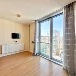 Bright modern room with large window and view.