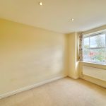 Empty room with window and radiator.