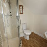 Modern bathroom with shower, toilet, and sink