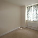 Empty room with floral curtains and carpet