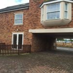 Brick house with bay window and driveway entrance