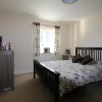 Modern bedroom with wooden furniture and decor