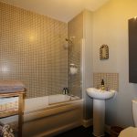 Modern bathroom with bathtub and sink.