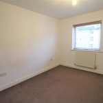 Empty bedroom with carpet and window blinds