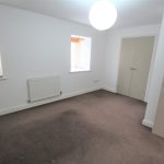 Empty room with white walls and carpet