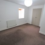 Empty room with carpet and window blinds.