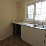 Small kitchen with sink and window.