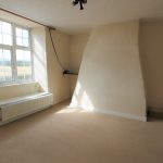 Empty room with window and beige walls