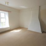 Bright empty room with window and radiator.