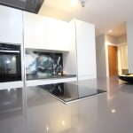 Modern kitchen with glossy surfaces and induction hob.