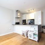 Modern kitchen with sleek appliances and wooden floor