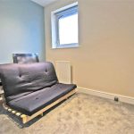 Small room with blue sofa bed.