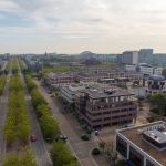 Milton Keynes aerial view, green street with buildings.