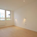Bright empty room with large windows.