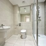 Modern bathroom with shower, sink, and toilet.