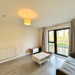 Modern living room with large window and sofa.