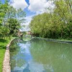 Peaceful canal with trees and bridge