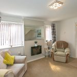 Cosy living room with armchair and sofa