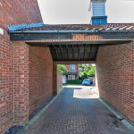 Brick archway leading to residential street view