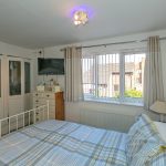 Cosy bedroom with plaid bedding and wardrobe