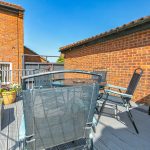Sunny patio with chairs and potted plants