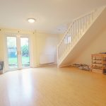 Bright living room with stairs and garden view.