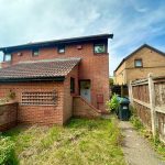 Red brick house with garden and fence