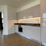 Modern kitchen with sleek cabinets and appliances.