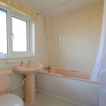 Vintage bathroom with peach fixtures and window