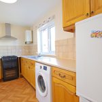 Modern kitchen with wooden cabinets and appliances