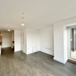 Modern open-plan kitchen and living area with balcony