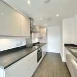 Modern fitted kitchen with sleek cabinets and appliances.