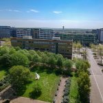 Aerial view of modern office buildings and green park.