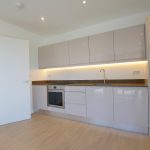 Modern kitchen with sleek cabinets and appliances.