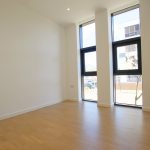 Empty room with large windows and wooden floor