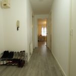 Hallway with shoe rack and room in view