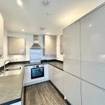 Modern kitchen with sleek design and integrated appliances.