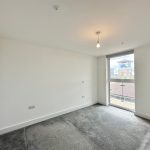 Empty room with window and grey carpet